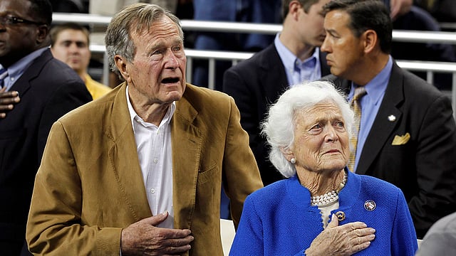 Former US President George HW Bush and his wife, former first lady Barbara Bush, stand during the national anthem prior to the University of Connecticut versus Butler University men`s final NCAA Final Four college basketball championship game in Houston, Texas, on 4 April 2011. Reuters File Photo