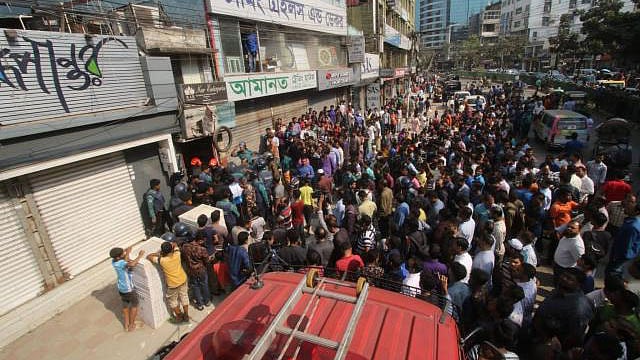 Law enforcement and locals are seen in front of the house.
