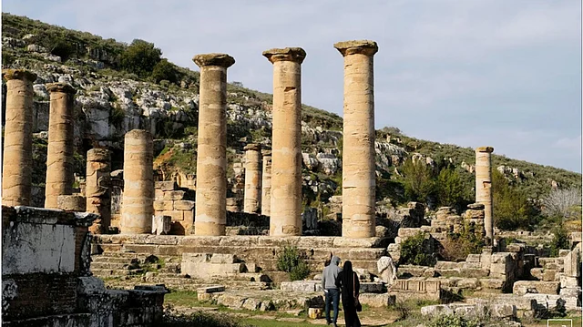 People stand next to the ancient ruins of the Greek and Roman city of Cyrene, in Shahhat, Libya, on 9 February 2019. Photo: Reuters