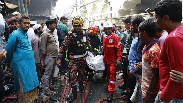 Firefighters take away a body from the fire spot on Thursday morning. Photo: Prothom Alo