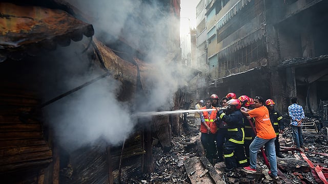 Firefighters try to extinguish a fire in Dhaka on 21 February 2019. Photo: AFP