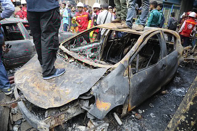 A car is completely burnt down in a fire that broke out in a five-storey building in Chawkbazar area at Old Dhaka on 20 February. Photo: Prothom Alo