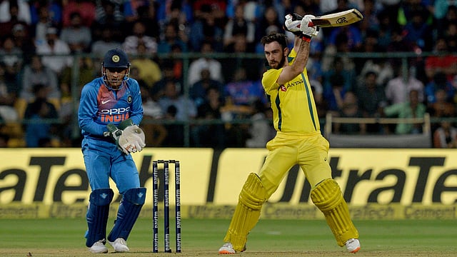 Australian batsman Glenn Maxwell (R) plays a shot while Indian wicket keeper MS Dhoni looks on during the second Twenty20 international cricket match between India and Australia at the M. Chinnaswamy Stadium in Bangalore on 27 February, 2019. Photo: AFP