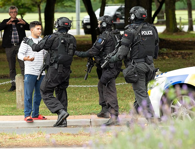 AOS (Armed Offenders Squad) push back members of the public following a shooting at the Masjid Al Noor mosque in Christchurch. Photo: Reuters