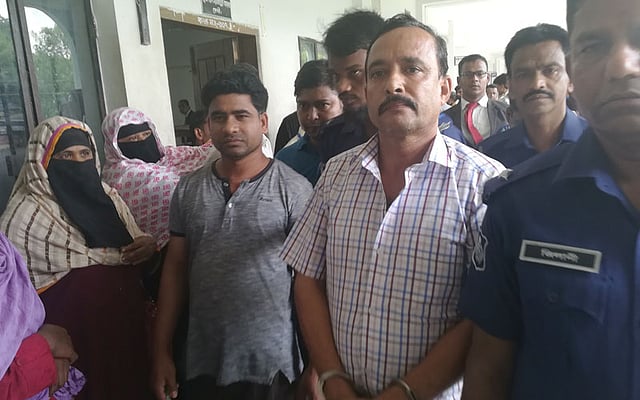 Members of police taking away Maksud Alam, accused in Nusrat murder case, after being produced in court. Photo: Protho Alo