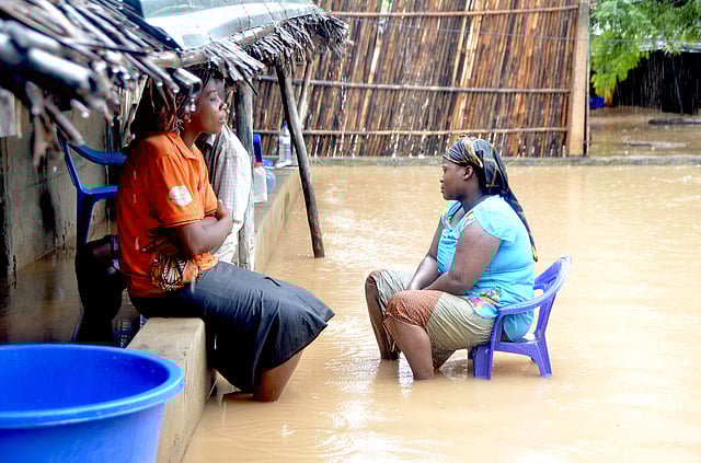 Neighbours chat while sitting in a flooded street of the Paquite district of Pemba on 29 April as Cyclone Kenneth hit northern Mozambique, killing 38 and destroying thousands of home. Photo:AFP