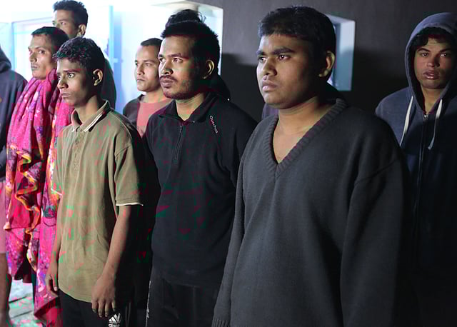 Survivors of a boat carrying migrants that sunk in the Mediterranean during the night of 9 and 10 May, gather at a shelter in the Tunisian coastal city of Zarzis on 11 May 2019. Photo: AFP