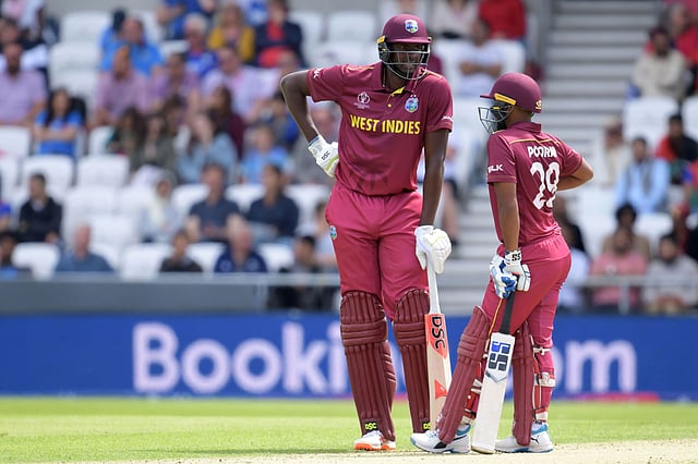 West Indies` captain Jason Holder (L) and West Indies` Nicholas Pooran chat during the 2019 Cricket World Cup group stage match between Afghanistan and West Indies at Headingley in Leeds, northern England, on 4 July, 2019. Photo: AFP