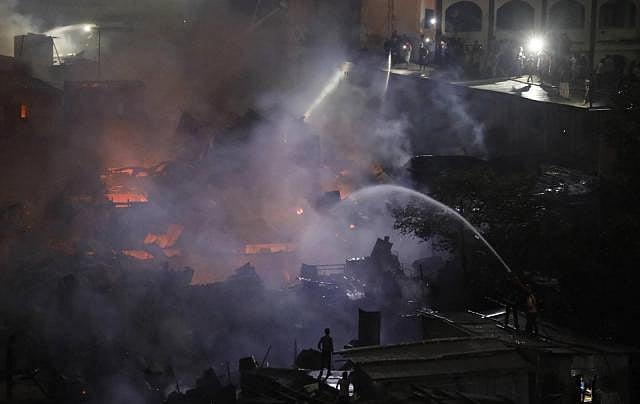 A total of 24 fire-fighting units working to douse Chalantika Slum fire in the capital`s Mirpur on 16 August, 2019. Photo: Dipu Malakar