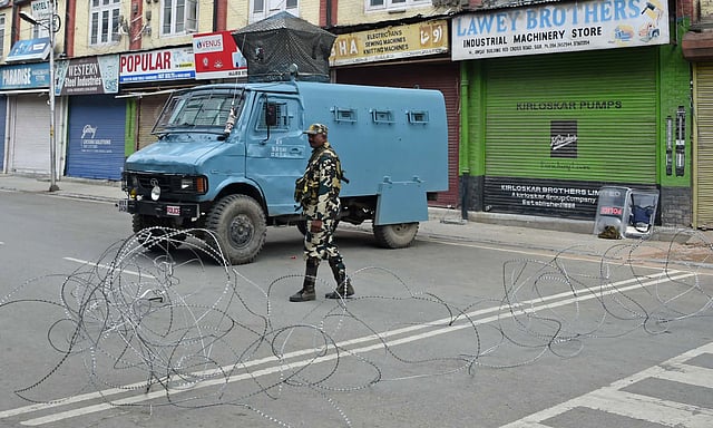 A member of the Indian security forces stands guard during a lockdown in Srinagar on 16 August 2019, after the Indian government stripped Jammu and Kashmir of its autonomy. Photo: AFP