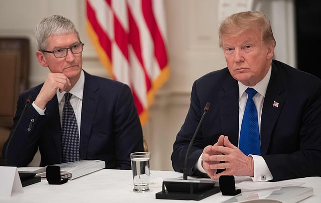 In this file photo taken on 06 March 2019 US president Donald Trump speaks alongside Apple CEO Tim Cook (L) during the first meeting of the American Workforce Policy Advisory Board in the State Dining Room of the White House in Washington, DC. Photo: AFP