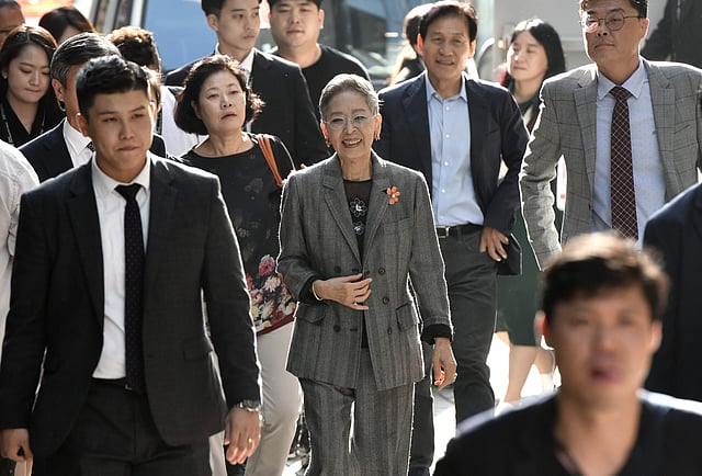 This picture taken on 4 October 2019 shows South Korean actress Kim Ji-mee (C) walking to attend a talk at the Busan International Film Festival (BIFF) in Busan. Photo: AFP