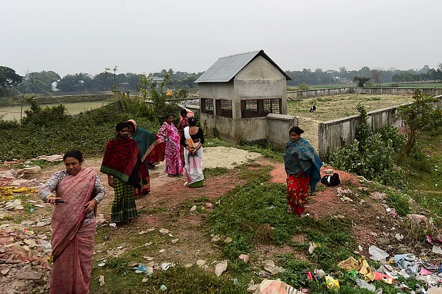This photograph taken on 8 February shows Jhumur Begum (L), who heads a sex workers group, walking with other members next to a graveyard used for the burial of sex workers in Daulatdia, Rajbari District, 110 kms (70 miles) west of Dhaka. Photo: AFP
