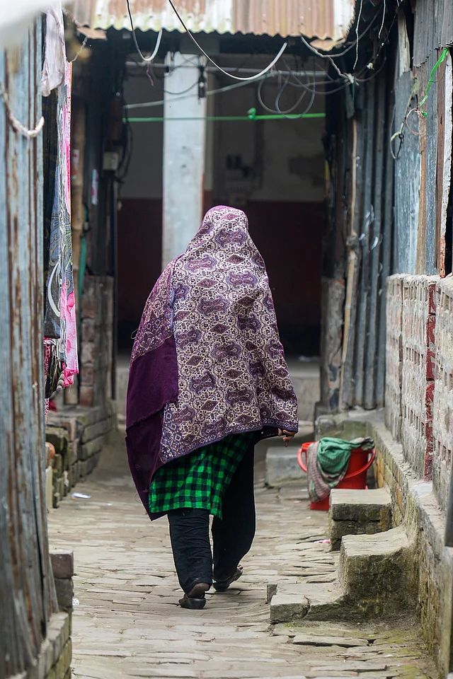 This photograph taken on 8 February shows a sex worker walking through a brothel area in Daulatdia in Rajbari District, 110 kms (70 miles) west of Dhaka. Photo: AFP