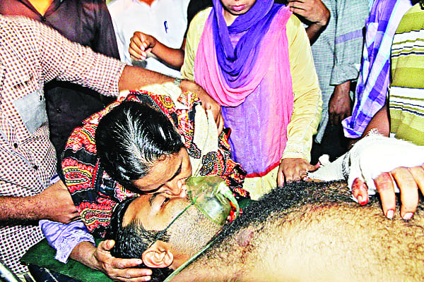শিবিরের হামলায় আহত ছেলে বেনজীর আহমেদকে জড়িয়ে মায়ের কান্না ষ ছবি: প্রথম আলো