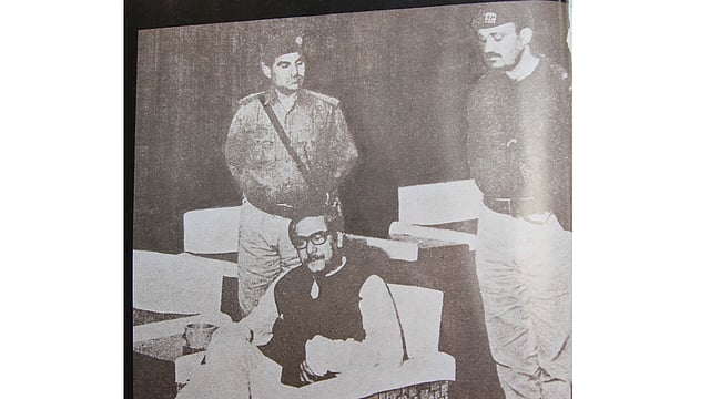 পাকিস্তানের করাচি বিমানবন্দরে বন্দী শেখ মুজিবুর রহমান (পাকিস্তান সরকারের পক্ষ থেকে প্রকাশিত আলোকচিত্র)। ছবি: মুক্তিযুদ্ধের আলোকচিত্র বই থেকে সংগৃহীত