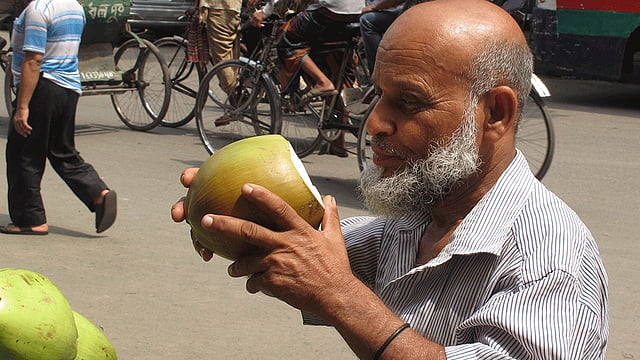 ডাবের পানিতে প্রাণ জুড়াচ্ছেন এক পথচারি। ছবিটি আজ সকাল ১০টার দিকে রাজধানীর জগন্নাথ বিশ্ববিদ্যালয়ের সামনের সড়ক থেকে তোলা। ছবি: মনিরুল আলম