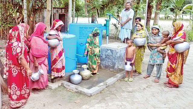খুলনার পাইকগাছা পৌরসভা এলাকায় একটি বেসরকারি সংস্থার নির্মিত ‘আর্সেনিক আয়রন রিমুভাল প্লান্ট’ থেকে খাওয়ার পানি সংগ্রহ করছেন এলাকাবাসী। সম্প্রতি তোলা ছবি l প্রথম আলো