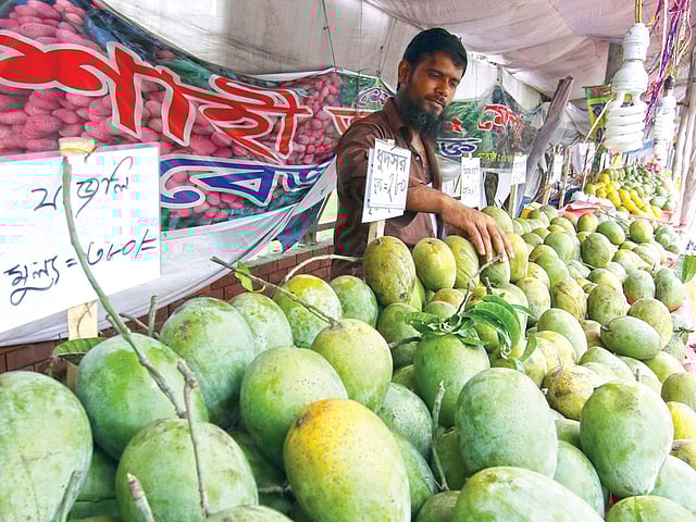 বাগানে আম নেই, কিন্তু রাজধানীর অনেক স্থানে এখনো চলছে আমের মেলা। আশ্বিনা জাতের আম বিভিন্ন নামে বিক্রি হচ্ছে এসব দোকানে। ছবিটি মঙ্গলবার ধানমন্ডি এলাকা থেকে তোলা l প্রথম আলো