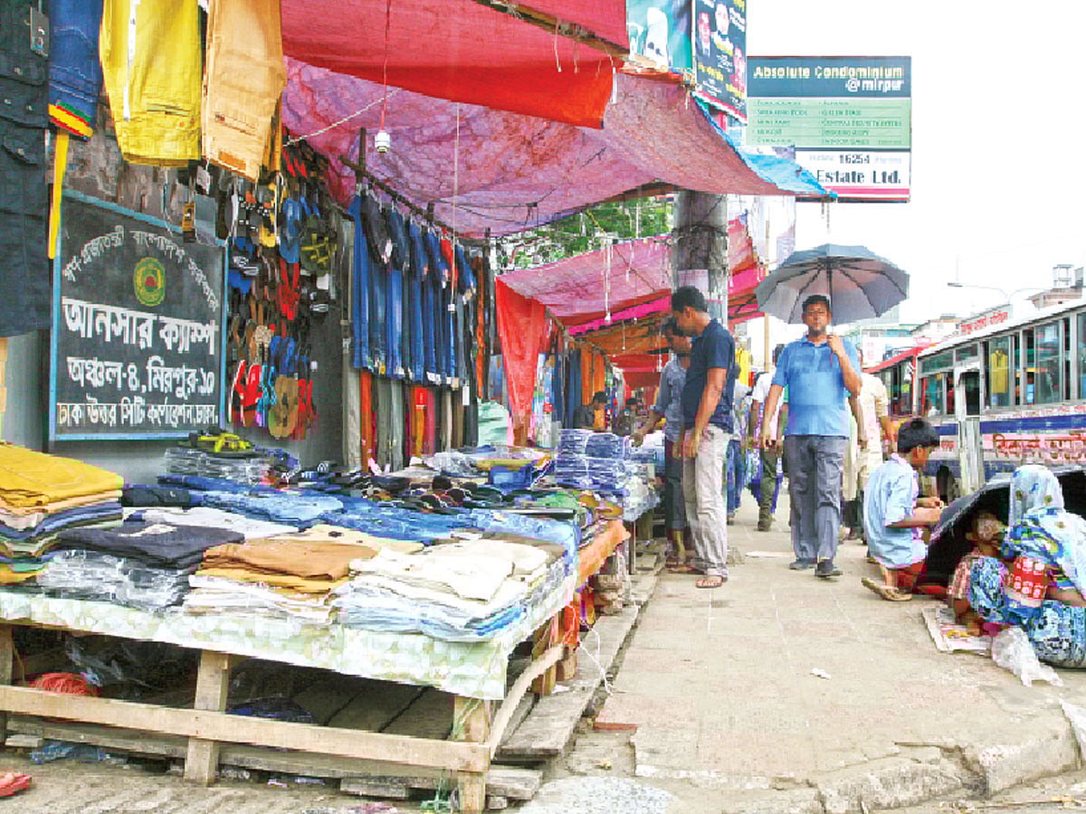 মিরপুরে ঢাকা উত্তর সিটি করপোরেশনের আঞ্চলিক কার্যালয়–৪–এর সামনেই ফুটপাত দখল। গত শনিবার ছবিটি তোলা l প্রথম আলো