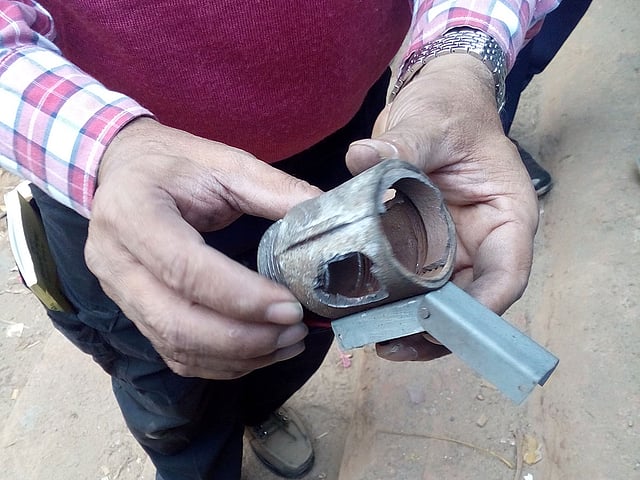 নিষ্ক্রিয় করার পরে একটি গ্রেনেডের খোল দেখাচ্ছেন এক কর্মকর্তা। ছবি: প্রথম আলো