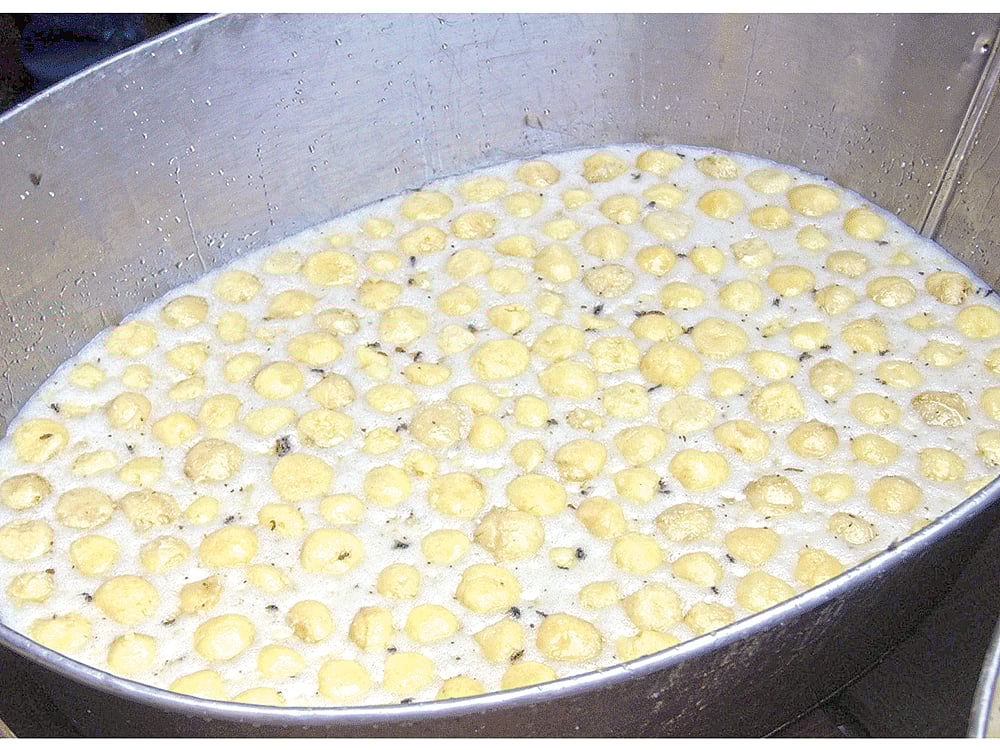 মিষ্টিতে ভাসছে মরা মাছি ও তেলাপোকা। গতকাল চট্টগ্রামের নন্দনকানন এলাকার একটি দোকানে l ছবি: প্রথম আলো