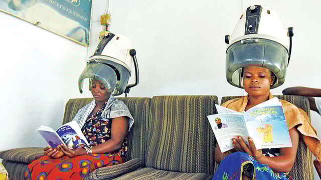 চুল পরিচর্যার মধ্যেই চলছে বই পড়া l ছবি: এএফপি