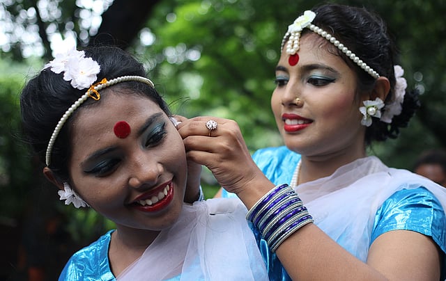 নাচের শুরুতে বান্ধবী ও সহশিল্পীর মাথায় ফুল পরিয়ে দিচ্ছেন একজন নৃত্যশিল্পী। ছবি: সাবিনা ইয়াসমিন