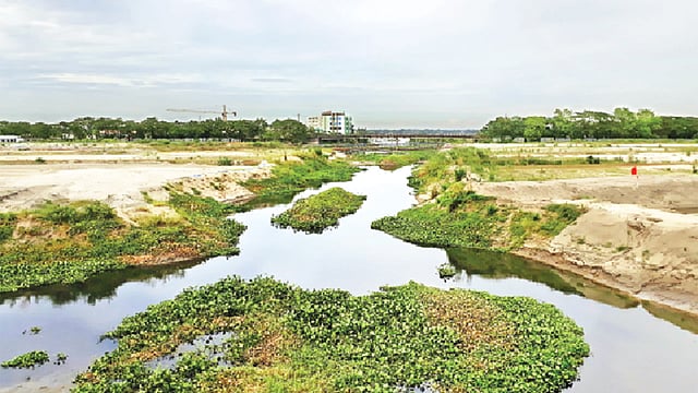 কুড়িল-পূর্বাচল ৩০০ ফুট সড়কের বোয়ালিয়া সেতুর নিচে খালের প্রশস্ততা দেড় শ ফুটের মতো। কিন্তু খালটি এখন একটি অংশে প্রস্থে কোথাও ৩০ ফুট, কোথাও ৪০ ফুটের মতো। এই অংশে পানির প্রবাহ নেই বললেই চলে l ছবি: অাবদুস সালাম