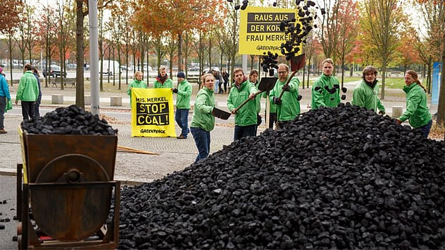 জার্মানির বার্লিনে কয়লাসহ জীবাশ্ম জ্বালানীর ব্যবহার দ্রুত বন্ধের দাবিতে পরিবেশবাদী সংগঠন গ্রীনপিসের কর্মীদের কয়লা ঢেলে দিয়ে প্রতিবাদ। ছবি: সরাফ আহমেদ