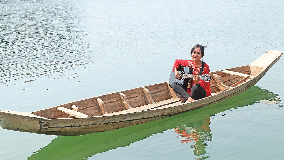 আপন মনে গাইছে তিসা দেওয়ান। ছবি: সুপ্রিয় চাকমা