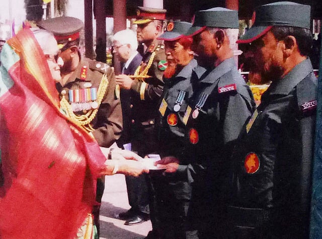 প্রধানমন্ত্রী শেখ হাসিনার কাছ থেকে সম্মাননা পেয়েছেন সিরাজ উদ্দিন (ডানে) ও লিয়াকত আলী। ছবি: সংগৃহীত