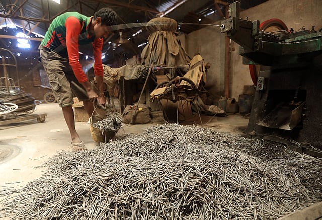 পেরেক তৈরির কারখানায় কাজ করছেন এক শ্রমিক। এ কারখানার শ্রমিকেরা দৈনিক ৩০০ থেকে ৪০০ টাকা মজুরি পান। আকার ভেদে প্রতি মণ পেরেকের দাম ৫ হাজার থেকে ৮ হাজার টাকা। মির্জাপুল এলাকা, চট্টগ্রাম, সাম্প্রতিক ছবি। ছবি: জুয়েল শীল