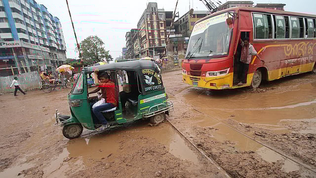 কাদা-জলে সয়লাব রেলগেট এলাকা। ধীর গতিতে চলছে যানবাহন।