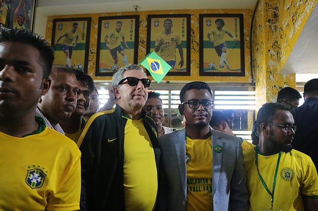 বাড়িটির দেয়ালে দেয়ালে সাঁটানো হয় ব্রাজিল দলের বিভিন্ন খেলোয়াড়ের ছবি। তা-ই ঘুরে ঘুরে দেখছেন ডি অলিভেরিয়া জুনিয়র। ফতুল্লা, নারায়ণগঞ্জ, ২২ জুন ছবি: দিনার মাহমুদ