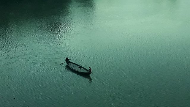 সন্ধ্যায় নৌকায় করে ফুলজোড় নদী পার হচ্ছেন তাঁরা। ধানগড়া, রায়গঞ্জ, সিরাজগঞ্জ, ৭ সেপ্টেম্বর। ছবি: সাজেদুল আলম