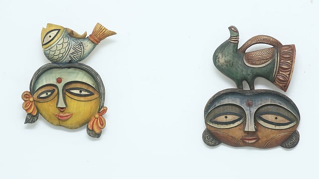 শিল্পী নামিরাহ ফারজানার দুটি কাঠের মুখোশ।