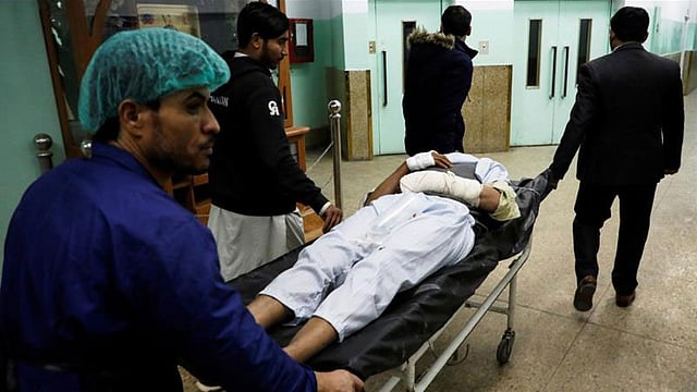 হামলায় আহত এক ব্যক্তিকে হাসপাতালে নেওয়া হয়েছে। ছবি: রয়টার্স