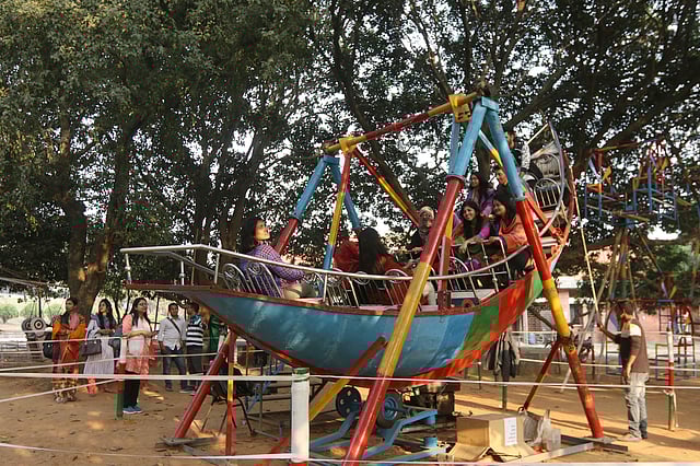 নৌকার আদলে তৈরি দোলনায় দর্শনার্থীরা।