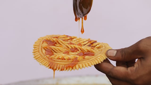 শিরায় ভেজানো হচ্ছে নকশি পিঠা।