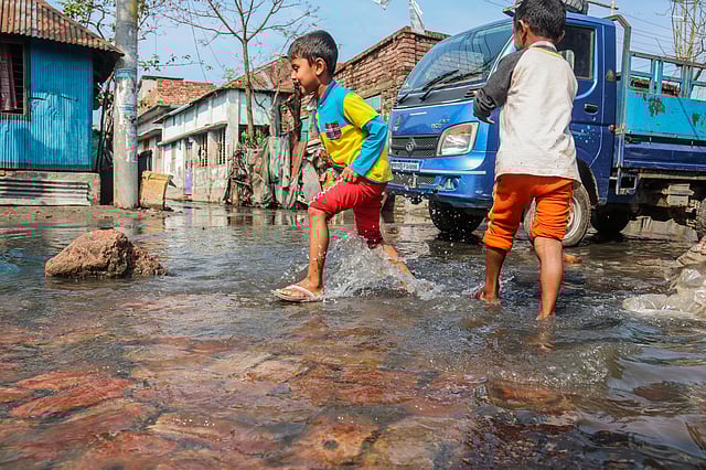 আষাঢ়-শ্রাবণ এখনো দেরি। কিন্তু ফাল্গুনেই লঘুচাপের বৃষ্টিতে ডুবে গেছে খুলনার বাস্তুহারা কলোনি। নোংরা পানিতে খেলছে দুই শিশু। ২৮ ফেব্রুয়ারি। ছবি: সাদ্দাম হোসেন