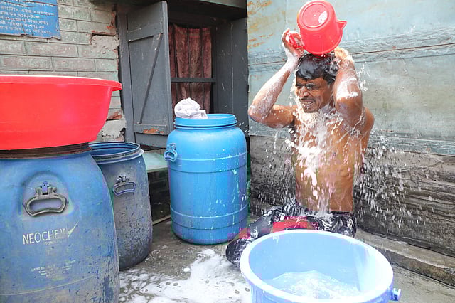 অল্প পানিতেই গোসল করতে হয় টিটিপাড়ার বস্তিবাসীর।