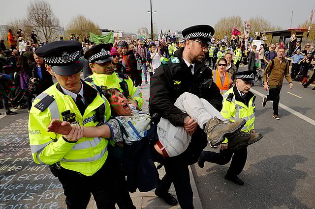 পরিবেশবাদী আন্দোলনকারী একজনকে গ্রেপ্তার করে নিয়ে যাচ্ছে পুলিশ। লন্ডন, যুক্তরাজ্য, ১৭ এপ্রিল। ছবি: এএফপি