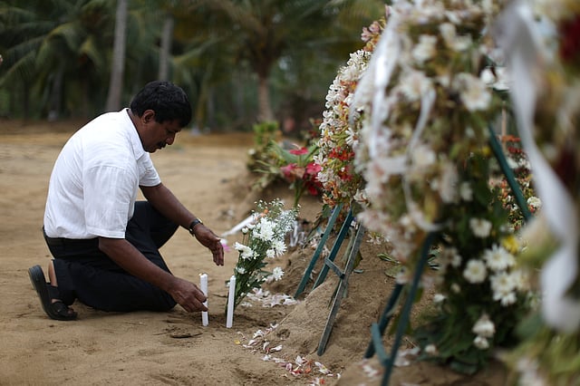 সেন্ট সেবাস্তিয়ান গির্জার কাছাকাছি কবরস্থানে এক স্বজনের প্রার্থনা। নেগোম্ব, শ্রীলঙ্কা, ২৮ এপ্রিল। ছবি: রয়টার্স