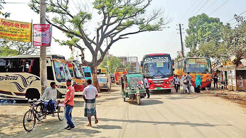 বাস টার্মিনাল থাকলেও সেখানে বাস যায় না। ভূঞাপুর উপজেলা সদরের ব্যস্ত রাস্তায় গড়ে উঠেছে অবৈধ বাসস্ট্যান্ড। ছবি: প্রথম আলো