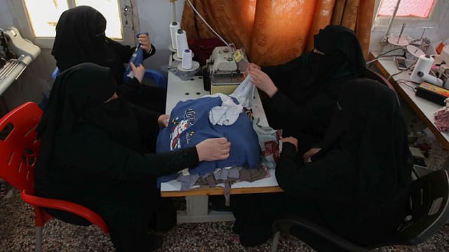 শিশুদের পোশাক তৈরির এই কারখানায় কাজ করেন হাসনা। ছবি: এএফপি