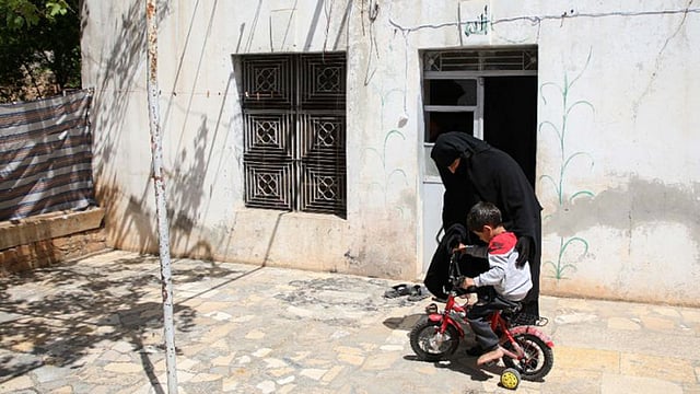 ছেলের সঙ্গে খেলছেন হাসনা। ছবি: এএফপি