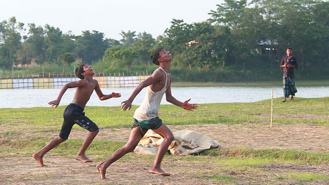 শূন্যে উঠেছে ফুটবল, পেছনে ছুটছে দুই কিশোর