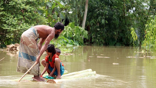 ঝুঁকি নিয়ে বন্যার পানিতে চলাচল।
