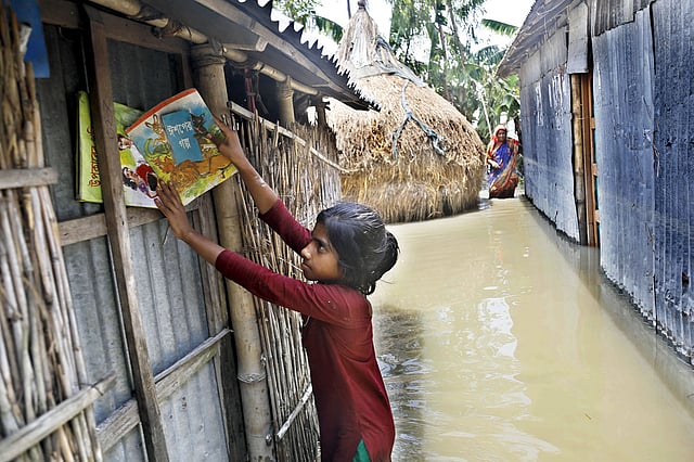 বন্যার পানি থেকে বই রক্ষা করার চেষ্টা